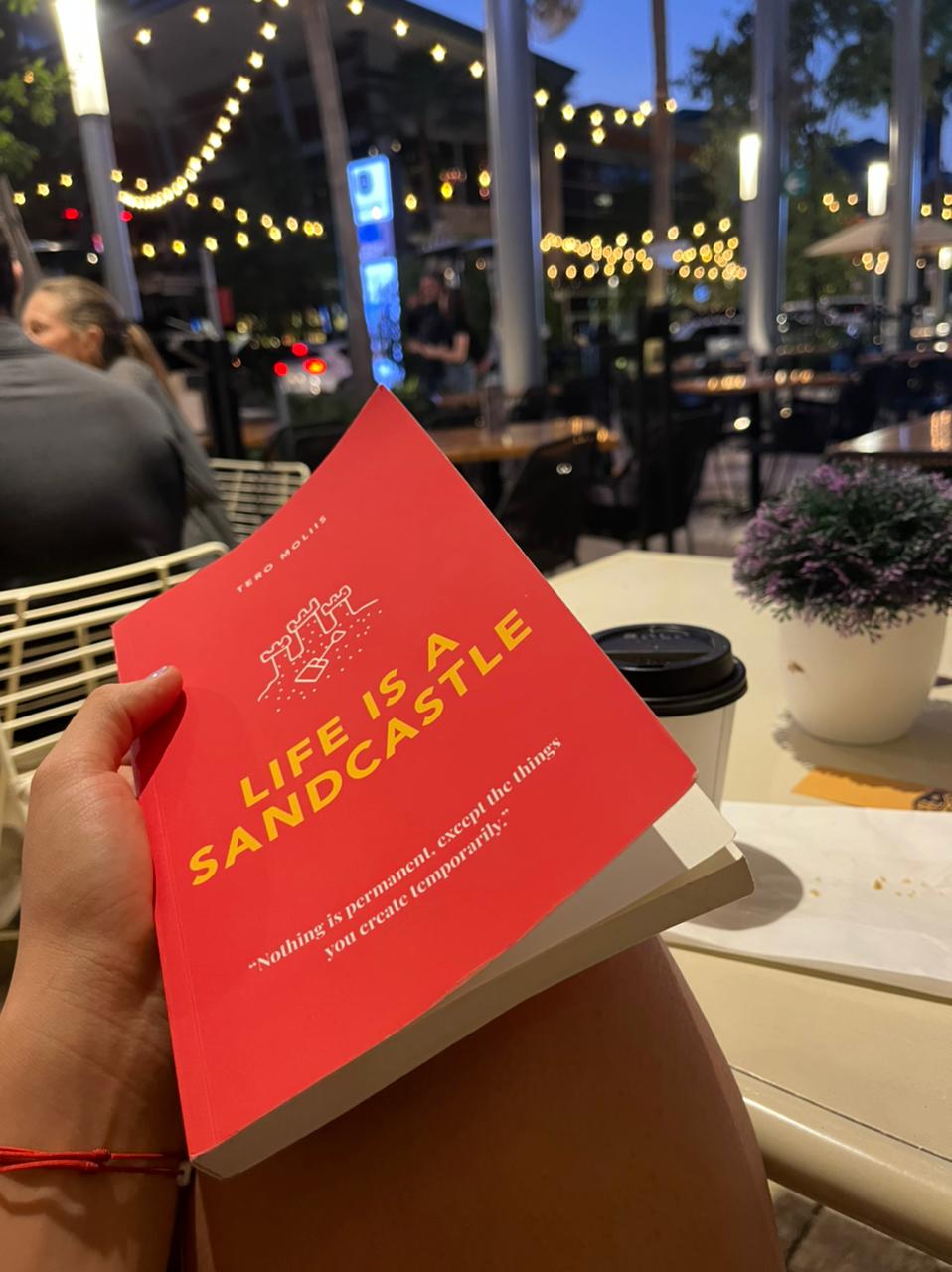 Life Is A Sandcastle book in a cafe