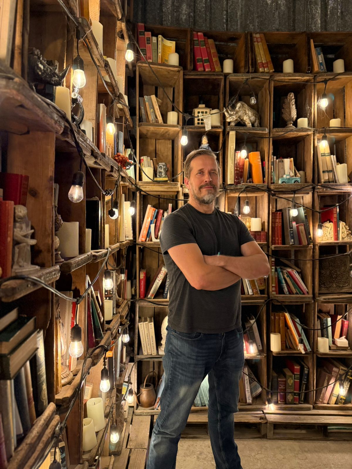 Tero Moliis in front of bookshelves