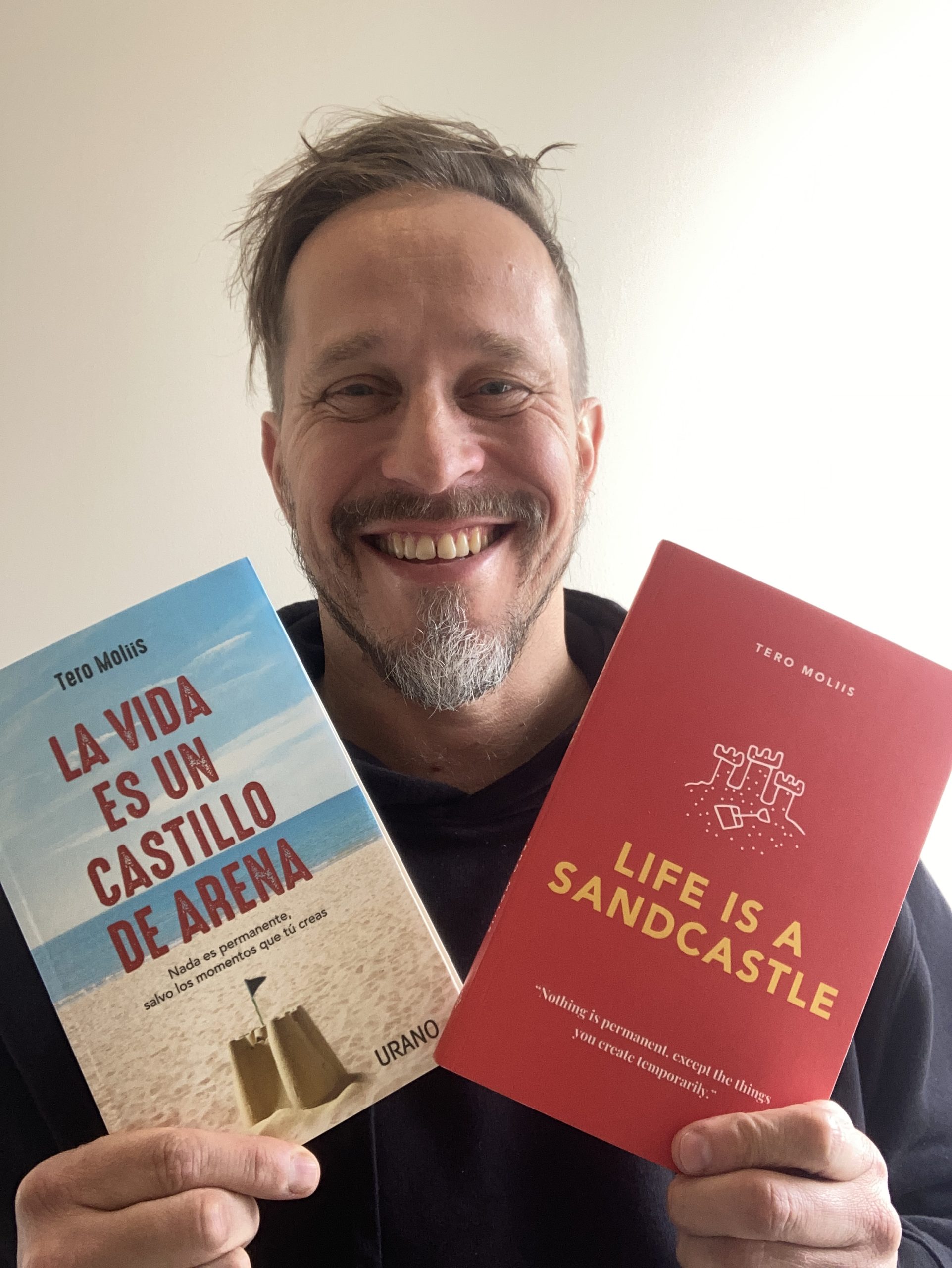 Tero Moliis holding both of his books